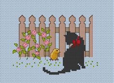 a black cat sitting in front of a fence with flowers and a bird on it