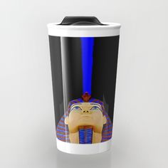 a cup with an image of the egyptian god nefer on it's side