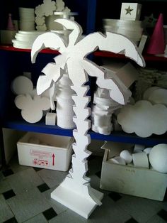 a cardboard palm tree sitting on top of a shelf