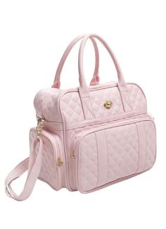 a pink handbag sitting on top of a white surface