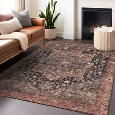 a living room with a couch, chair and rug in front of a fire place