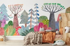 a child's bedroom with colorful trees and plants painted on the wall behind it