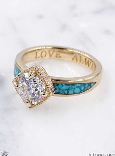 a close up of a ring with a diamond on the top and blue stones around it