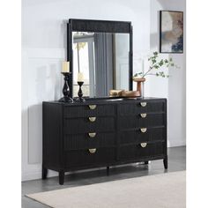 a black dresser and mirror in a room