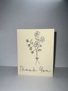 a thank you card with flowers drawn on it