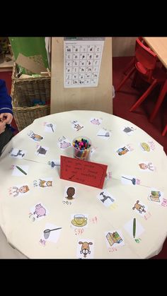 a child sitting at a table with a sign on it