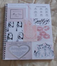 an open notebook with pictures of cats and other things on the pages, including a date book