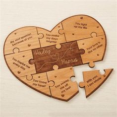 a wooden heart shaped puzzle with two pieces missing