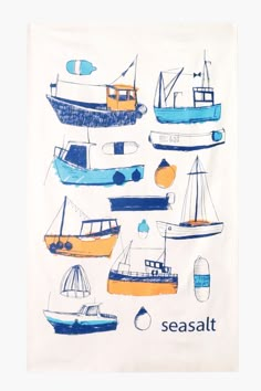 a tea towel with boats on it and the words seasalt written in blue