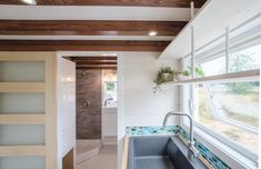 the interior of a tiny house with a sink and window in it's center