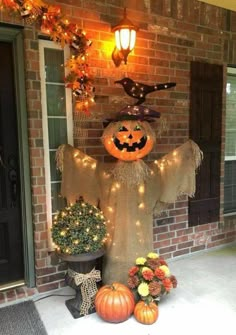 a decorated front porch with pumpkins and lights