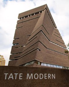 the tate modern building in london, england is made out of brick and has a large triangular shape