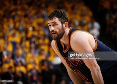 a basketball player is looking down at the court