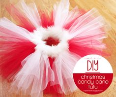 a red and white tutu sitting on top of a wooden floor next to a sign that says diy christmas candy cone tutu