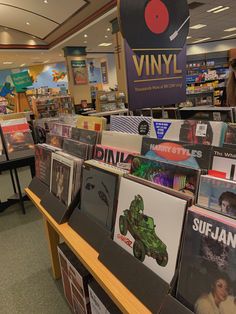 an assortment of vinyl records are on display in the store's music section,