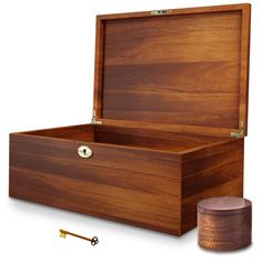 an open wooden box with a key on the side and a small container next to it