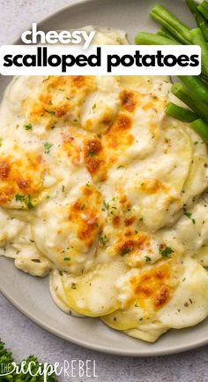 a white plate topped with ravioli and green beans