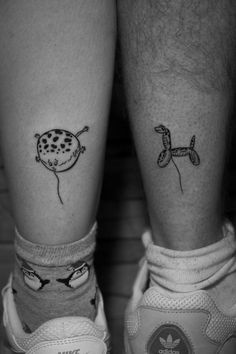 two people with tattoos on their legs