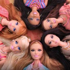 several dolls laying on top of each other in the middle of a circle with their heads together