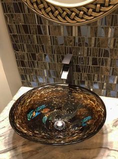 a bathroom sink sitting under a mirror next to a faucet