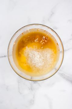 a glass bowl filled with liquid on top of a marble counter