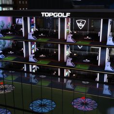 the topgol booth is lit up at night with neon lights and umbrellas on display