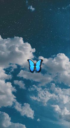 a blue butterfly flying in the sky with clouds and stars above it on a sunny day