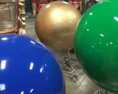 several different colored balloons on display in a store