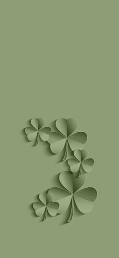 four leaf clovers are arranged in the shape of an e on a green background