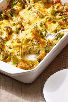 a casserole dish with broccoli and cheese in it on a wooden table