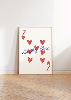 a white frame with red hearts and the words i love you written in blue ink