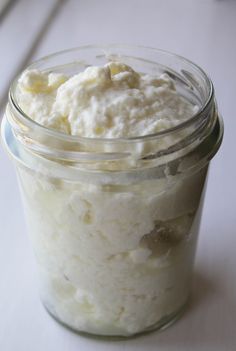 a jar filled with whipped cream sitting on top of a table