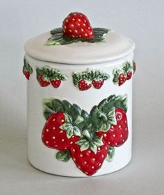 a ceramic container with strawberries painted on it