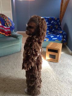 a dog dressed up in a costume standing on the floor