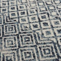 a blue and white area rug with an intricate design on the bottom half of it