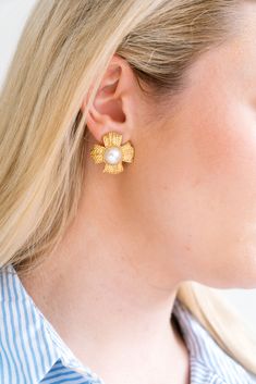 a close up of a person wearing some kind of earring with pearls on it