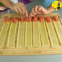 someone is making ravioli on a cutting board