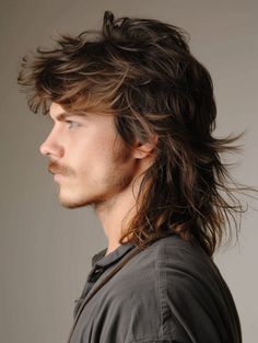 For those who love a retro vibe, the mullet-inspired wolf cut is a bold choice that combines the best of both worlds. This style features shorter layers on top and longer, flowing locks at the back, creating a striking contrast. Perfect for parties and edgy fashion events, this cut suits square and rectangular faces, complementing blue or green eyes. Punk Mens Hair, Layered Mullet Men, Rockstar Mullet, Longer Mullet, Grown Out Mullet, Mens Wolf Cut, Layered Mullet, Mullet Korean, Long Slicked Back Hair