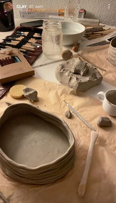 a table topped with lots of different types of pottery