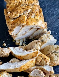 sliced chicken breast with herbs and seasoning on it