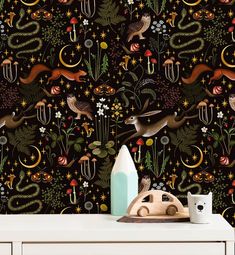 an image of a wallpaper with animals and plants on the side table in front of it