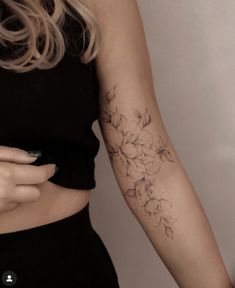 a woman with a flower tattoo on her arm