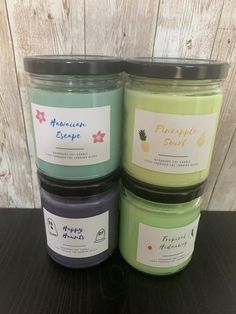 three jars of candles sitting next to each other