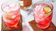 two glasses filled with pink lemonade and ice