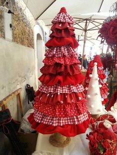 several red and white christmas trees are on display