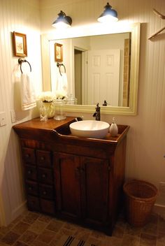 a bathroom with a sink, mirror and rug on the floor in front of it