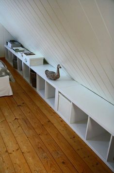 a bed room with a neatly made bed and some shelves on the wall next to it