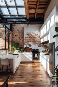 an open kitchen with exposed brick walls and wooden floors