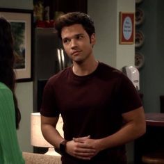 a man standing next to a woman in a living room on the set of friends