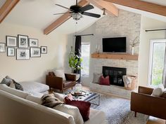 a living room filled with furniture and a flat screen tv mounted on the wall above a fire place